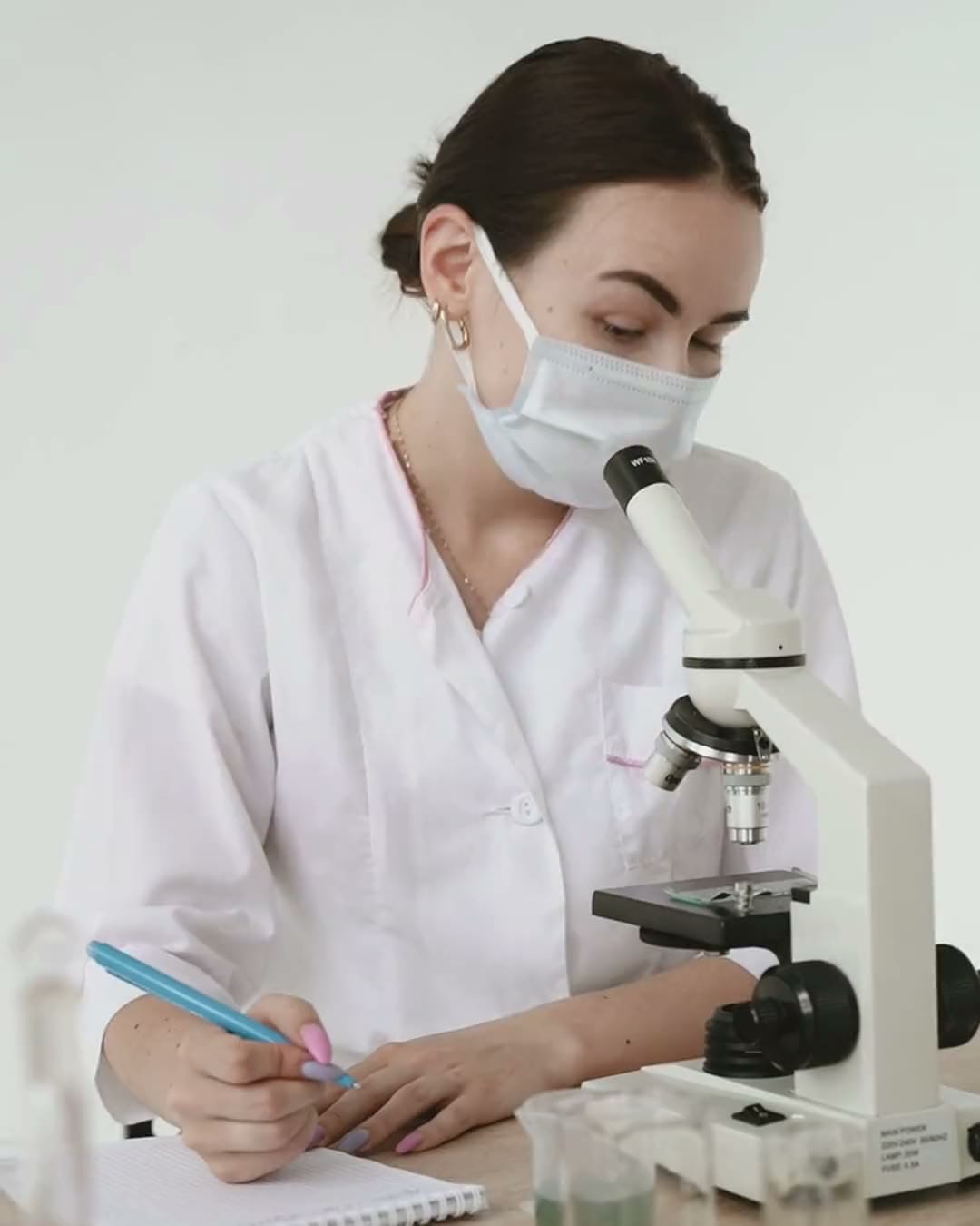 A short film: a scientist at a microscope, a doctor with a young patient, a team at work and a family at home