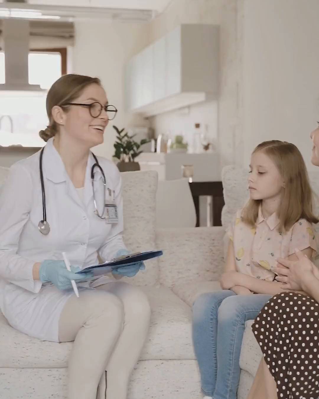 A short film: a doctor with a young patient, a team at work, a clinician in a lab coat, a family at home and a scientist at a microscope